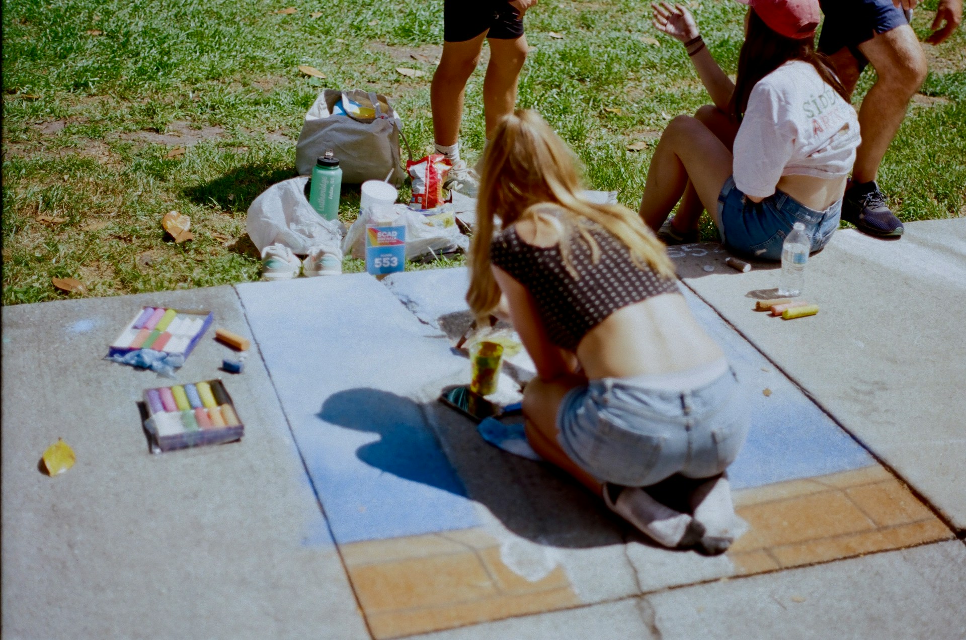 a student painting in a park
