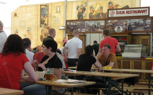 Food and beer being consumed at a restaurant in Prague.